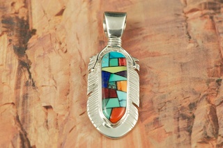 Genuine Turquoise, Spiny Oyster Shell and Blue Lapis inlaid in Sterling Silver. Beautiful Mosaic Design. Free 18" Sterling Silver Chain with Purchase of Pendant. Feather Pendant Designed by Navajo Artist Calvin Begay. Signed.